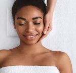Woman in a spa having her face massaged
